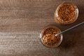 Jars and spoon of whole grain mustard on wooden table, flat lay. Space for text Royalty Free Stock Photo