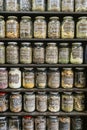 Jars on a store shelf labled with various spices