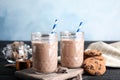 Jars with tasty chocolate milk on wooden table Royalty Free Stock Photo