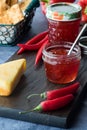 Jars of delicious homemade hot chili pepper jelly with cheese and crackers. Royalty Free Stock Photo