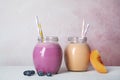 Jars of tasty milk shakes and fresh fruits Royalty Free Stock Photo