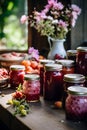 Jars with various jams and flowers on a wooden table 4 Royalty Free Stock Photo