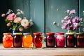 Jars with various jams and flowers on a wooden table 5 Royalty Free Stock Photo