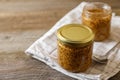 Jars of whole grain mustard on wooden table. Space for text Royalty Free Stock Photo