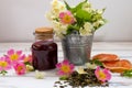 Jasmine dry green tea leaves with jasmine flowers ,with flowers of wild roses and raspberry jam Royalty Free Stock Photo