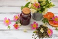 Jasmine dry green tea leaves with jasmine flowers ,with flowers of wild roses and raspberry jam Royalty Free Stock Photo