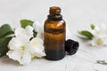 Jasmine essential oil. Bottle of jasmine aromatherapy oil with d Royalty Free Stock Photo