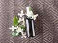 Jasmine flowers and bottle full of oil for beauty treatments.Top view of spray bottle with jasmine oil