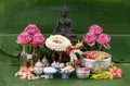 Jasmine garland and Colorful flower in water bowls decorating and scented water, perfume, marly limestone, pipe gun on Banana leaf