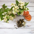 Jasmine green tea leaves with jasmine flowers on white background. Royalty Free Stock Photo