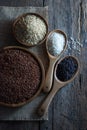 Jasmine red rice in a wooden tray, jasmine brown rice in a wooden bowl placed on sackcloth, jasmine rice, and purple-brown rice in Royalty Free Stock Photo