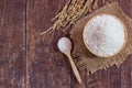 Jasmine rice in bowl and paddy rice on old wooden table Royalty Free Stock Photo