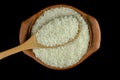 Jasmine rice in a clay pot and the wood ladle on white background Royalty Free Stock Photo