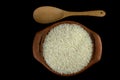 Jasmine rice in a clay pot and the wood ladle on white background Royalty Free Stock Photo