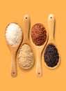 Rice in wooden ladle on yellow orange color background top view with clipping path. Royalty Free Stock Photo