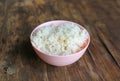 Jasmine rice in pink plate on wooden table