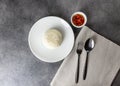 Jasmine rice serve on a plate with spoon and fork in restaurant, plate of steamed white rice