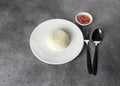 Jasmine rice serve on a plate with spoon and fork in restaurant, plate of steamed white rice