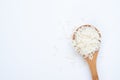 Jasmine rice on wooden spoon, isolated on white background Royalty Free Stock Photo