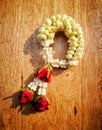 Jasmine with rose garlands lay on the wooden desk. Royalty Free Stock Photo