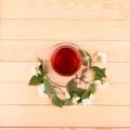 Jasmine tea and jasmine flowers on wooden background, top view Royalty Free Stock Photo