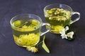 Jasmine tea and linden flowers tea.Cups of hot herbal tea with jasmine fresh flowers and linden Royalty Free Stock Photo