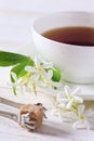 Jasmine tea in a white bone china cup and brown sugar Royalty Free Stock Photo