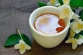 Jasmine tea in a white cup with fresh jasmine flowers on old wooden table.Healthy drink,diet or herbal medicine concept. Royalty Free Stock Photo