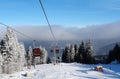 View of the ski slope, cableway and low clouds in the Jasna ski
