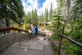 Tourists walk along the network of stairs to see Athabasca Falls waterfall along the