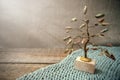 Jasper and wire tree in the rays of light on knitted fabric and Royalty Free Stock Photo