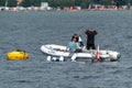 Jastarnia, Poland - 08.01.2021: Male diver dressing up to black neoprene, standing on a small white motor boat tied to