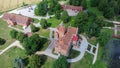 Jaunmoku Brick Medieval Castle Near Tukums, Latvia at Pond With Fontain in Clear Sunny Summer Day From Above Top View.