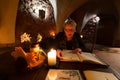 A mature woman peruses a menu in the dining room in the medieval 14th Century Jaunpils Castle,