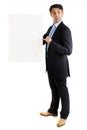 Jaunty salesman pointing to a blank sign