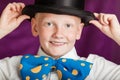 Jaunty young boy in a bow-tie and top hat