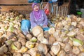 JAVA, INDONESIA - December 18 2016: Sales woman selling coconuts