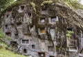 Java, Indonesia, June 13, 2022 - Prestigious Toraja citizens are buried in manually carbed out slots in a rock hillside Royalty Free Stock Photo