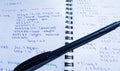 Translations of calculus systems on a notebook and black pen. creation of computer programs. work of the programmer and system Royalty Free Stock Photo