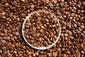 Java. Roasted coffee beans in a paper cup lid against the background of beans Royalty Free Stock Photo