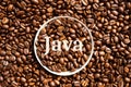 Java. Roasted coffee beans in a paper cup lid against the background of beans Royalty Free Stock Photo