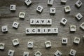 Java Script word made of square letter word on wooden background
