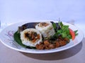 a Javanese cash dish, namely arem-arem. The food is made of rice and filled with usually shredded chicken