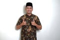 Javanese man giving two thumbs up and showing happy face expression