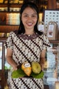 Javanese woman shows cocoa fruit in the `Monggo` Chocolate Museum, Yogyakarta