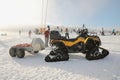 JAVORNIK, CZECH - 31 December 2016: Parked yellow snowmobile CAN-AM OUTLANDER in a winter setting, winter scooter