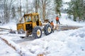 Jaworki, Poland - January 26, 2019; Forestry tractor and woodcutters during the export of wooden logs from the mountain forest