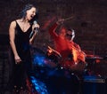 Jazz band performance. Couple of musicians - a drummer and a singer in a nightclub. Royalty Free Stock Photo