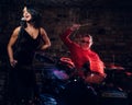 Jazz band performance. Couple of musicians - a drummer and a singer in a nightclub. Royalty Free Stock Photo