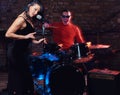 Jazz band performance. Couple of musicians - a drummer and a singer in a nightclub.